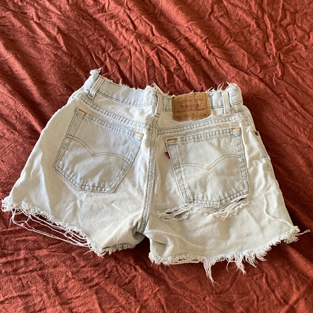 Vintage light blue distressed Levi’s vintage shorts with tear in the back